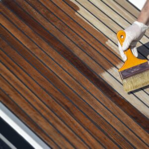 Deks Olje D1 being applied to a boat deck with a brush