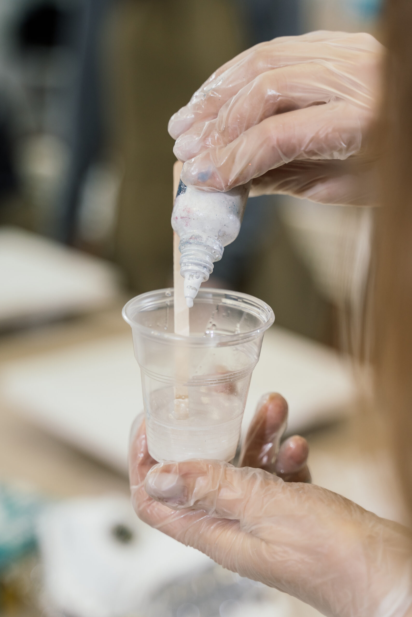 lady placing pigment into resin