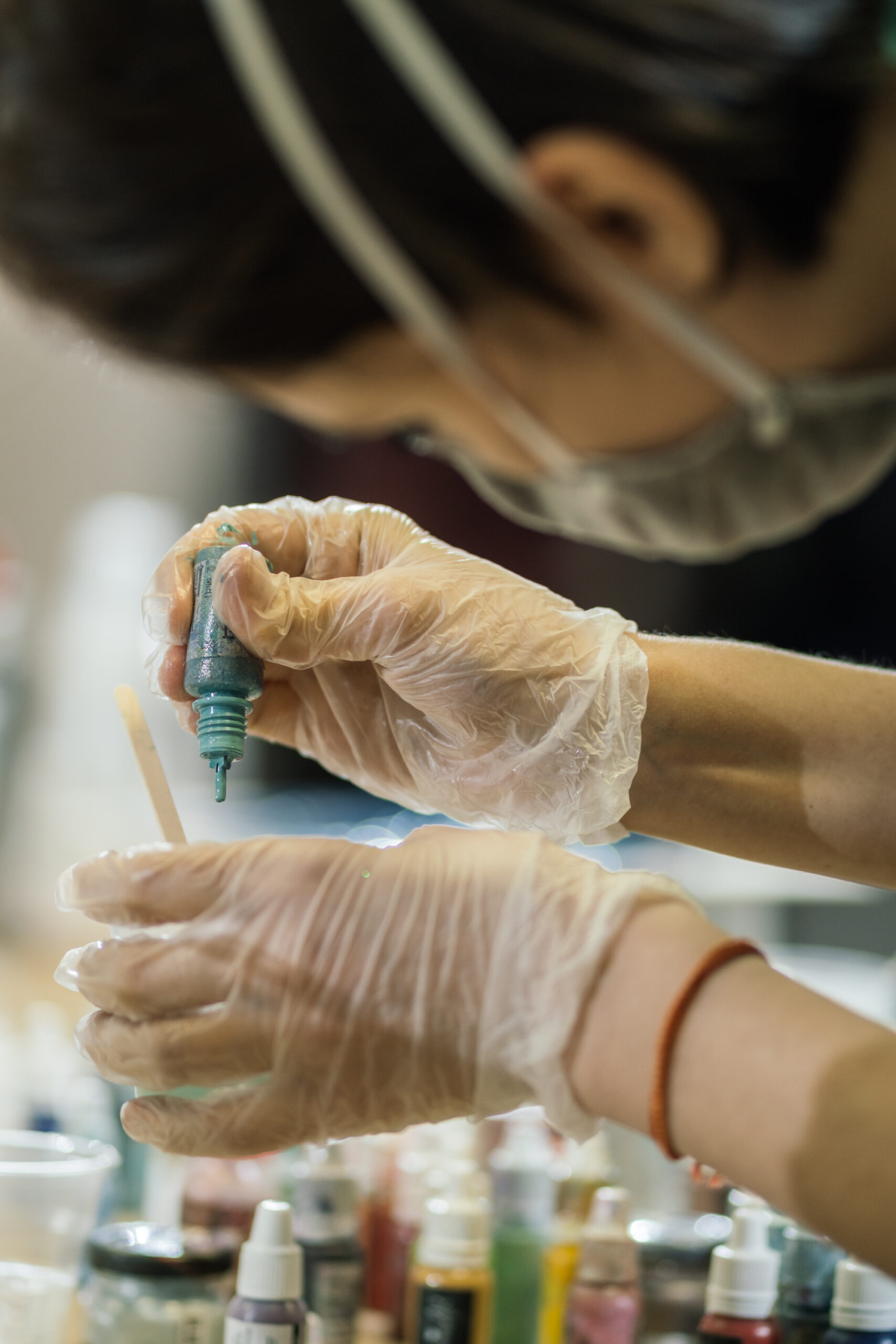 Lady adding pigment to resin