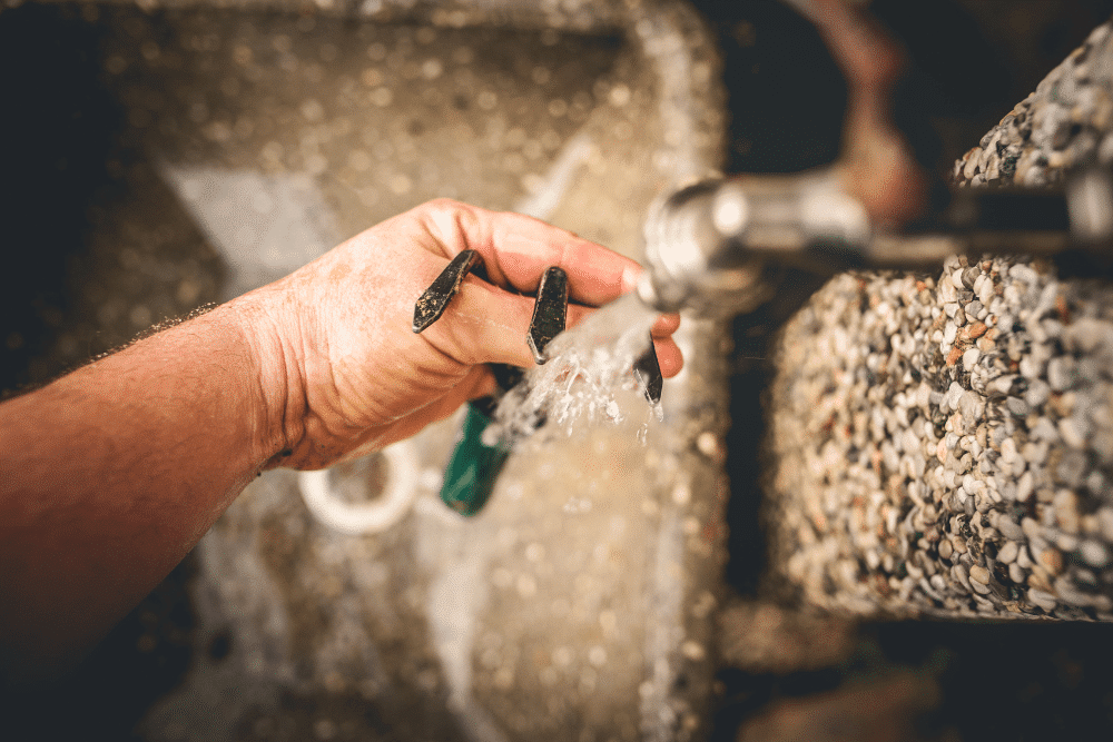 rinsing gardening tool in water